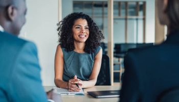 Shot of group of business persons in business meeting. Three entrepreneurs on meeting in board room. Corporate business team on meeting in modern office. Female manager discussing new project with her colleagues. Company owner on a meeting with two of her employees in her office.